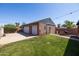 Backyard with a two-car garage, BBQ, green grass, and string lights at 1546 W Culver St, Phoenix, AZ 85007