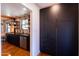 Stylish kitchen with dark cabinetry, stainless steel appliances, and industrial shelving accenting the exposed brick wall at 1546 W Culver St, Phoenix, AZ 85007