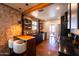 Contemporary kitchen featuring black cabinetry, stainless steel appliances, and exposed brick at 1546 W Culver St, Phoenix, AZ 85007