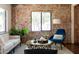 Charming living room with brick wall, contemporary furniture, and stylish accents at 1546 W Culver St, Phoenix, AZ 85007