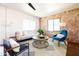 Bright living room with modern decor, exposed brick wall, and comfortable seating at 1546 W Culver St, Phoenix, AZ 85007
