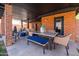 Inviting covered patio area with dining and lounge spaces with brick pillars at 1546 W Culver St, Phoenix, AZ 85007