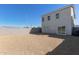 Gravel backyard offering ample space, complemented by a two-story home and a block fence at 1564 N Pueblo Dr, Apache Junction, AZ 85120