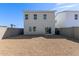 Large, gravel backyard featuring a two-story home with a sliding glass door and privacy wall at 1564 N Pueblo Dr, Apache Junction, AZ 85120
