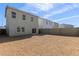 Spacious gravel backyard with a two-story home and block wall for privacy at 1564 N Pueblo Dr, Apache Junction, AZ 85120