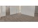 Carpeted bedroom with hallway access, featuring modern design elements and neutral colors at 1564 N Pueblo Dr, Apache Junction, AZ 85120