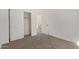 Bedroom with carpet flooring, a closet with sliding doors and an open door at 1564 N Pueblo Dr, Apache Junction, AZ 85120