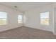 Bright bedroom with carpet, three large windows providing natural light, and a modern aesthetic at 1564 N Pueblo Dr, Apache Junction, AZ 85120