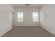 Bright bedroom with carpet, two large windows providing natural light, and a modern aesthetic at 1564 N Pueblo Dr, Apache Junction, AZ 85120