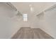 Walk-in closet with carpet flooring, a window, and shelving for ample storage at 1564 N Pueblo Dr, Apache Junction, AZ 85120