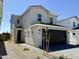 Charming two-story home featuring neutral stucco, stone accents, a black garage door, and desert landscaping at 1564 N Pueblo Dr, Apache Junction, AZ 85120
