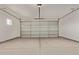 Spacious two-car garage featuring concrete flooring and an automatic door at 1564 N Pueblo Dr, Apache Junction, AZ 85120
