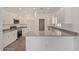 Bright kitchen with gray granite countertops, stainless appliances, white cabinetry, and tile floors at 1564 N Pueblo Dr, Apache Junction, AZ 85120