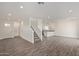 Open-concept living space with wood look tile, stairs and view of kitchen and entry at 1564 N Pueblo Dr, Apache Junction, AZ 85120