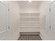 Walk-in pantry with ample shelving and modern tile flooring, ideal for organized storage at 1564 N Pueblo Dr, Apache Junction, AZ 85120