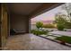 Spacious covered back patio with lounge seating overlooking the well-manicured backyard at 18025 N 65Th Pl, Phoenix, AZ 85054