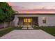 Inviting covered patio overlooks the beautifully landscaped backyard with lush green grass and tiled space, perfect for outdoor living at 18025 N 65Th Pl, Phoenix, AZ 85054