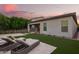 Beautiful backyard featuring artificial grass, lounge chairs, and landscaping at 18025 N 65Th Pl, Phoenix, AZ 85054