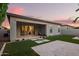 Inviting backyard featuring artificial turf, stone pavers, and a covered patio area at 18025 N 65Th Pl, Phoenix, AZ 85054