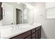 Bathroom with a double sink vanity, large mirror, and a window providing natural light at 18025 N 65Th Pl, Phoenix, AZ 85054