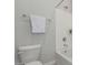 Bathroom featuring a toilet, tub/shower combo, towel rack, and neutral color palette at 18025 N 65Th Pl, Phoenix, AZ 85054