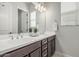Bright bathroom featuring a double sink vanity with white counter and wood cabinets at 18025 N 65Th Pl, Phoenix, AZ 85054