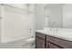 Well-lit bathroom featuring a tub/shower combo, toilet, and sink with wood cabinets at 18025 N 65Th Pl, Phoenix, AZ 85054