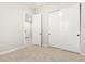 Neutral bedroom with carpet floors, white trim, and closet with white sliding doors at 18025 N 65Th Pl, Phoenix, AZ 85054