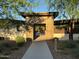 Community entrance featuring modern architecture, desert landscaping, and well-maintained walkway at 18025 N 65Th Pl, Phoenix, AZ 85054