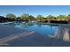 Community pool area with clear blue water, serene landscaping, and plenty of space for residents at 18025 N 65Th Pl, Phoenix, AZ 85054