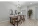 Formal dining room with a wooden table, seating for six, contemporary lighting, and a view into the living area at 18025 N 65Th Pl, Phoenix, AZ 85054