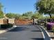 Gated community entrance with desert landscaping, a secure and welcoming environment at 18025 N 65Th Pl, Phoenix, AZ 85054