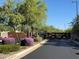 Gated community entrance with desert landscaping creating a secure and welcoming environment at 18025 N 65Th Pl, Phoenix, AZ 85054