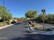 Gated community entrance featuring lush landscaping and a secure, inviting entry point at 18025 N 65Th Pl, Phoenix, AZ 85054