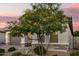 Home exterior featuring a landscaped front yard and a two-car garage at 18025 N 65Th Pl, Phoenix, AZ 85054
