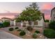 Charming home exterior featuring a landscaped front yard and a two-car garage at 18025 N 65Th Pl, Phoenix, AZ 85054