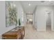 Well-lit hallway with stylish wood-look flooring, neutral walls, and a decorative console table at 18025 N 65Th Pl, Phoenix, AZ 85054