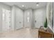 Entryway featuring a console table, white doors, and wood-look floors offering a welcoming view into the home at 18025 N 65Th Pl, Phoenix, AZ 85054
