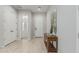 Entrance hallway boasting wood-look floors, white trim, and a decorative table, leading into the home at 18025 N 65Th Pl, Phoenix, AZ 85054