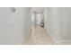 Long hallway with wood look floors and white walls at 18025 N 65Th Pl, Phoenix, AZ 85054