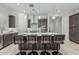 Contemporary kitchen featuring a large island with seating and stylish pendant lighting at 18025 N 65Th Pl, Phoenix, AZ 85054