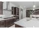 Gourmet kitchen featuring a gas cooktop, subway tile backsplash, and stainless steel hood at 18025 N 65Th Pl, Phoenix, AZ 85054