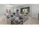 Inviting living room with neutral tones, comfortable seating, and a sliding door offering views of the outdoor space at 18025 N 65Th Pl, Phoenix, AZ 85054