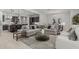 Bright, open-concept living room showcasing a modern design with a large sectional sofa and adjacent kitchen at 18025 N 65Th Pl, Phoenix, AZ 85054