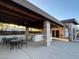 Community outdoor lounge with seating, grilling area, and a view of the nearby pool and facilities at 18025 N 65Th Pl, Phoenix, AZ 85054