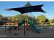 Community playground featuring a covered structure with slides, climbing features, and play areas at 18025 N 65Th Pl, Phoenix, AZ 85054