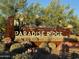 Community entrance sign for 'Paradise Ridge' amidst desert landscaping, marking the neighborhood's identity at 18025 N 65Th Pl, Phoenix, AZ 85054