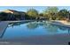 Community swimming pool with reflections and a view of nearby homes at 18025 N 65Th Pl, Phoenix, AZ 85054