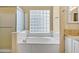 Bathroom featuring soaking tub with glass block window and shower stall at 1975 E Chilton Dr, Tempe, AZ 85283