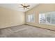 Bright bedroom boasts a high ceiling, fan, shutters, and carpet flooring at 1975 E Chilton Dr, Tempe, AZ 85283